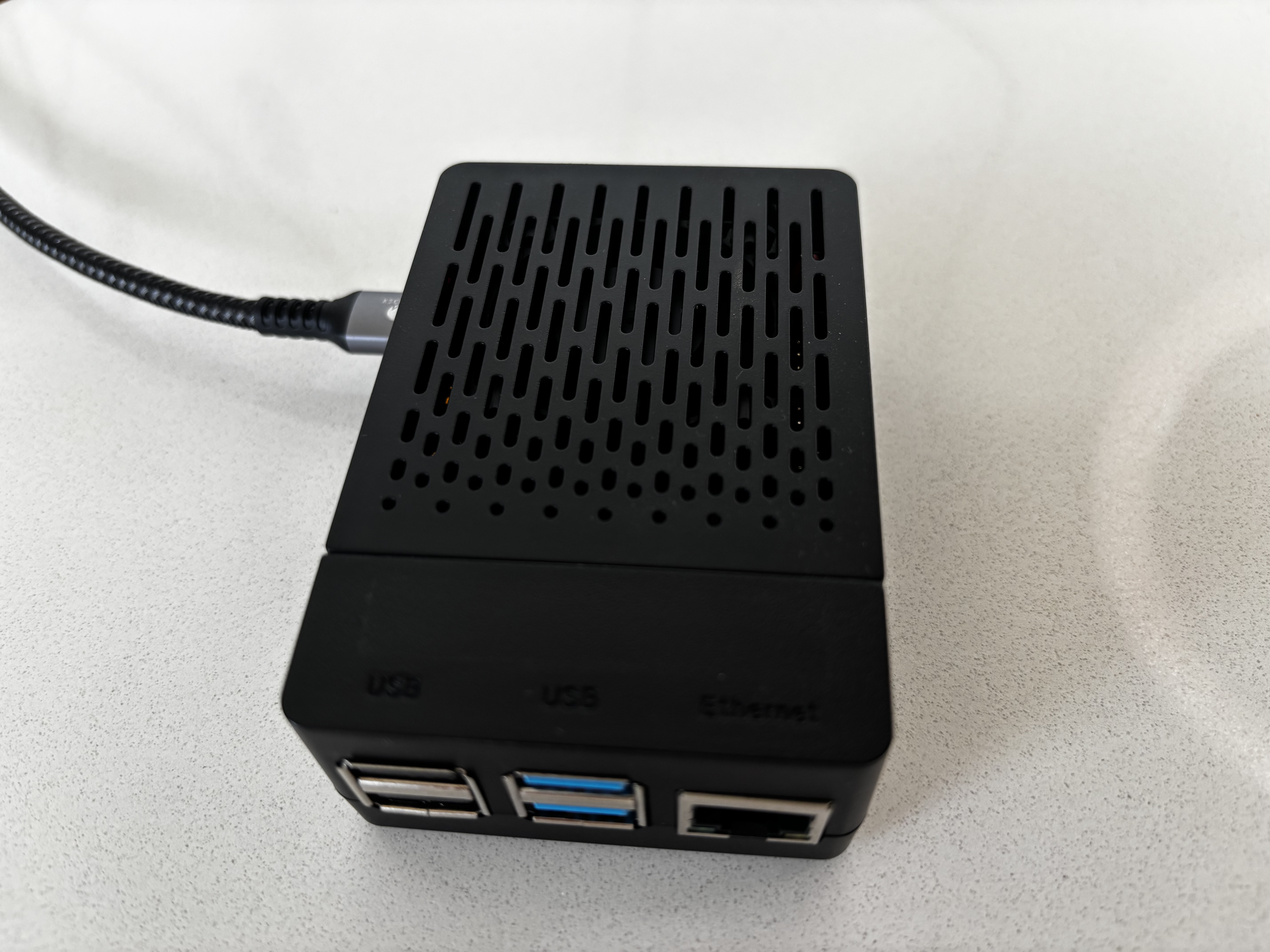 Tesla Video Manager device showing vented enclosure and cable connection